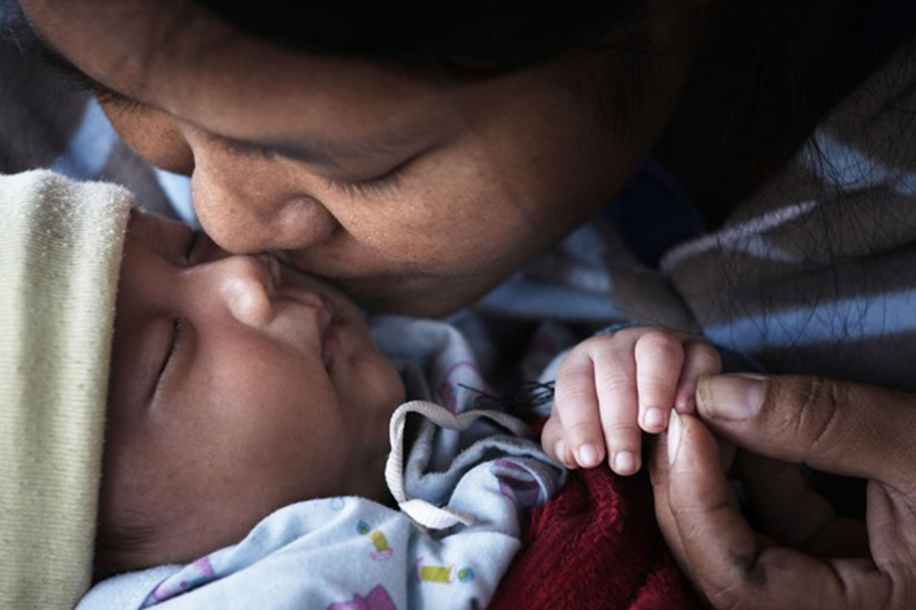 Woman and baby kissing