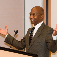 Donald Hopkins speaking at podium