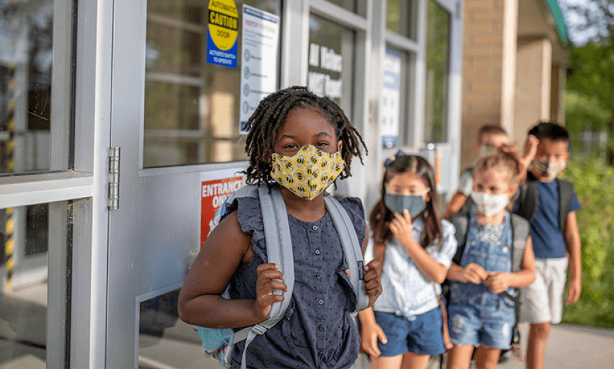Young school children wearing masks 