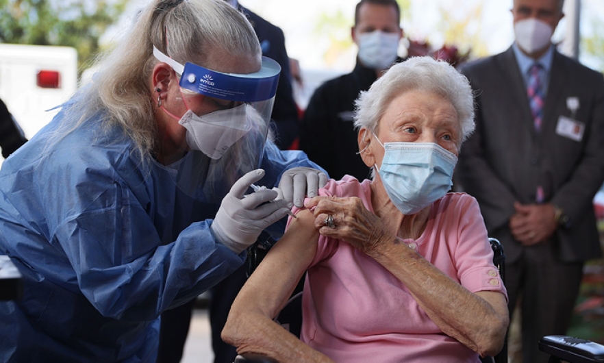 Elderly woman getting a vaccine, photo credit, Joe Raedle