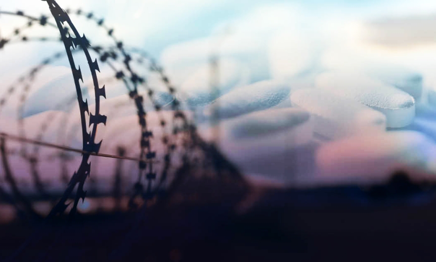 Barbed wire around prison with pills 