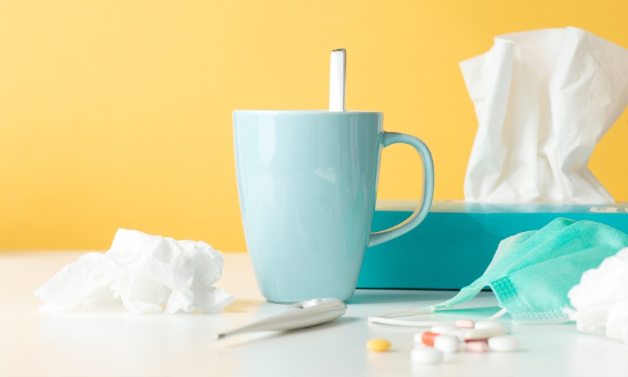 tissue box, coffee mug and thermometer