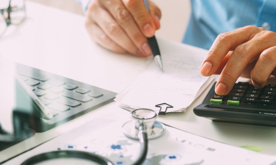 Doctor writing at a desk