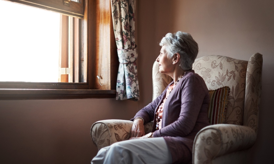 Older Woman Sitting By Window