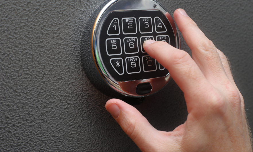 A person inputting a code on a safe lock