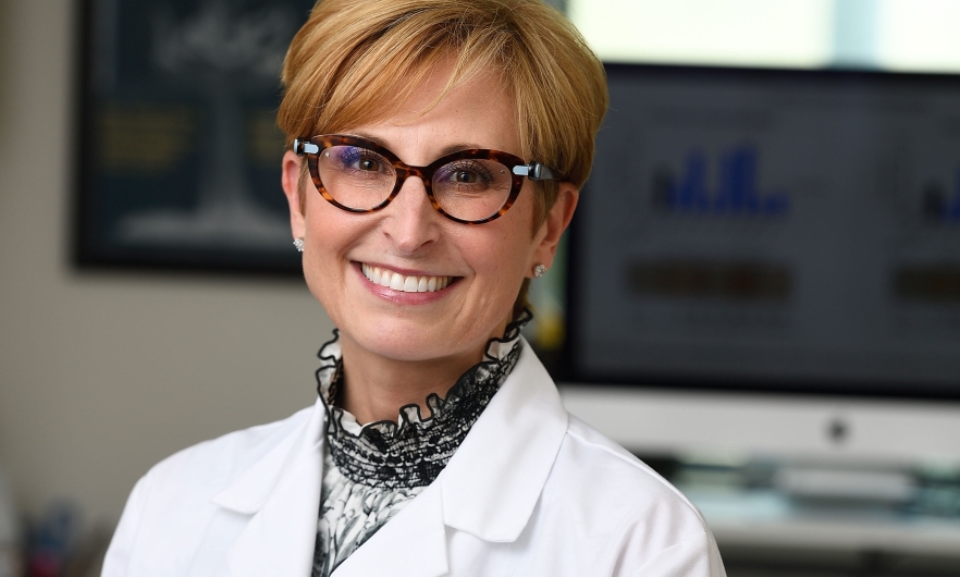 Photo of Sabra Klein in a white lab coat