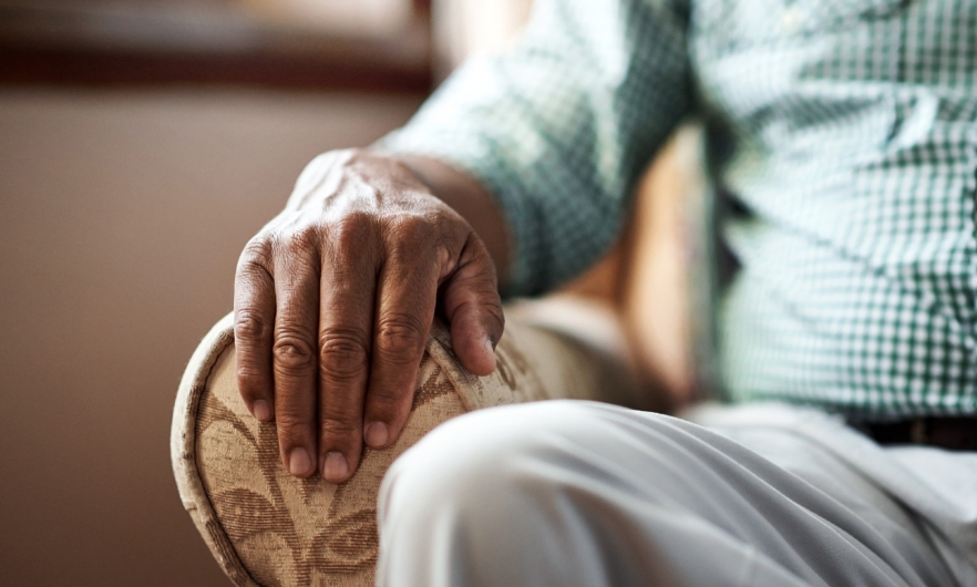 image of an elderly man sitting in a chair 