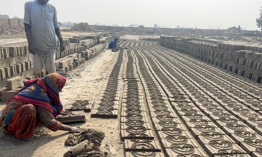 Brick kiln workers laying bricks in Pakistan