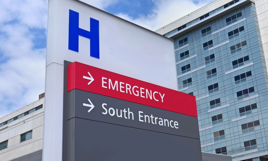 Outdoor sign that reads Emergency and South Entrance