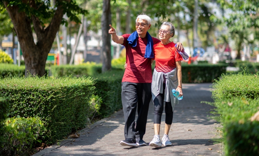 photo of older couple walking in park