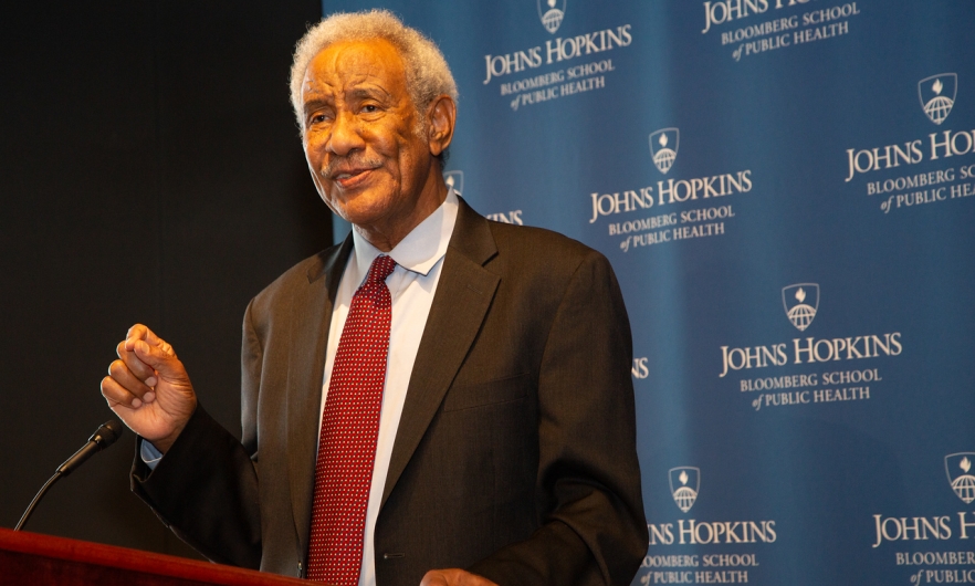 Dr. Taha Taha standing at a podium