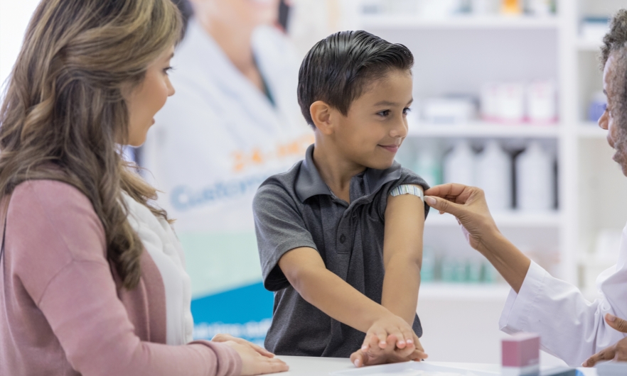 Child smiling after receiving a vaccination