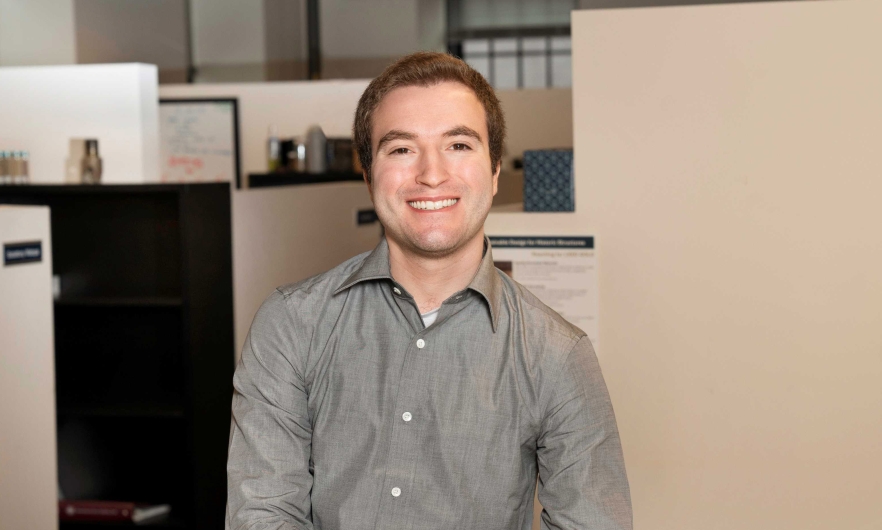 man in button-down shirt standing in an office