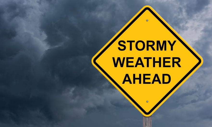 A yellow sign that says Stormy Weather Ahead