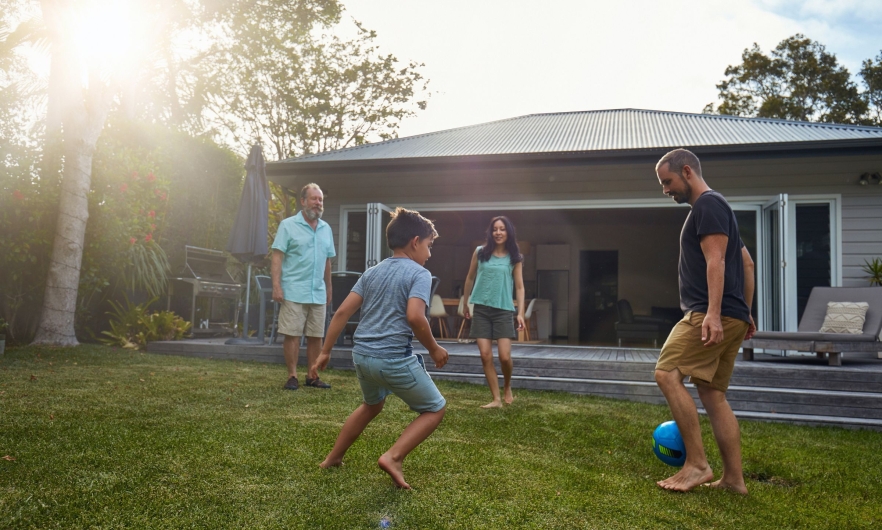 Family playing soccer outdoors Family playing soccer outdoors