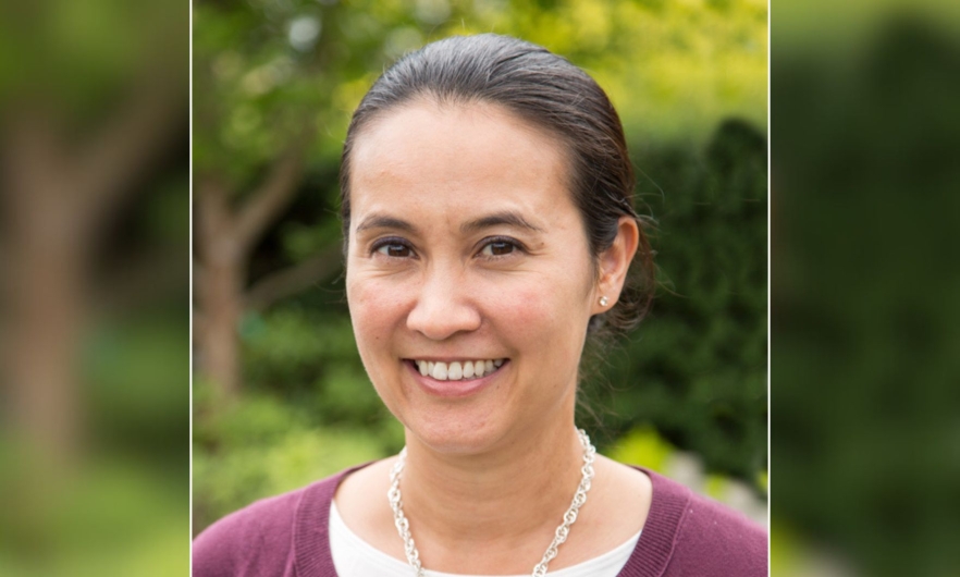 A headshot of Bianca Frogner, a woman with dark-colored hair slicked back in a ponytail