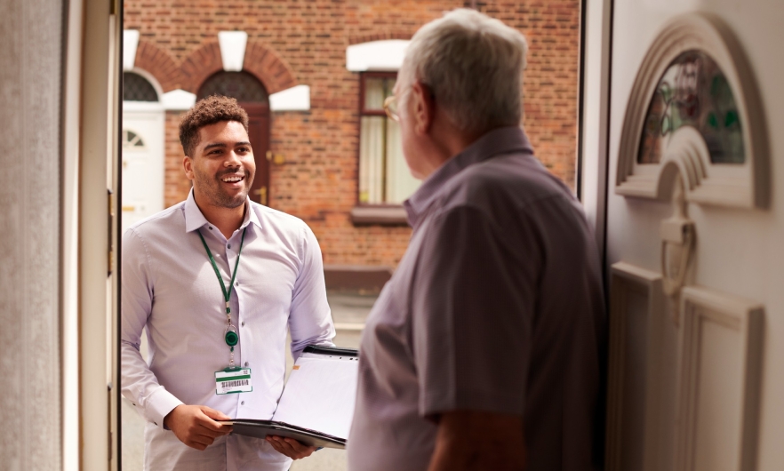 Young man talking to senior citizen