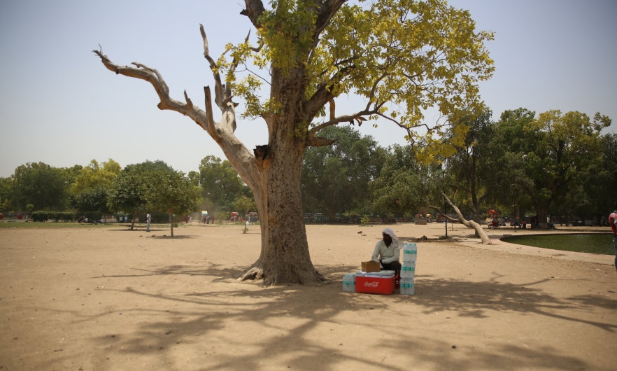 A man takes rest from selling water bottles on a hot afternoon near India Gate in Delhi. 