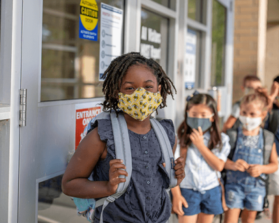 Young school children wearing masks 