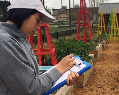 woman taking notes in urban farm