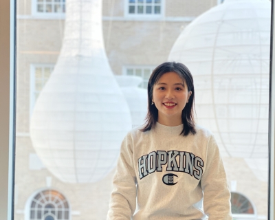 Young woman in Hopkins shirt in front of a window