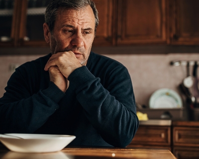 Man thinking at kitchen table