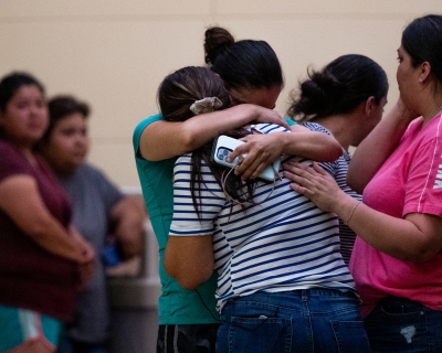 Photograph of people mourning.