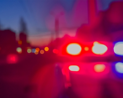 Red and blue police car lights at night time