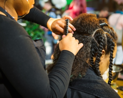 Black female hairdresser working with a black female client