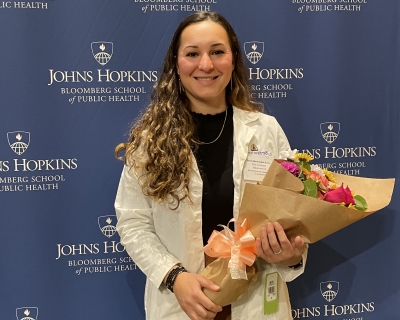 woman smiling holding bouquet of flowers