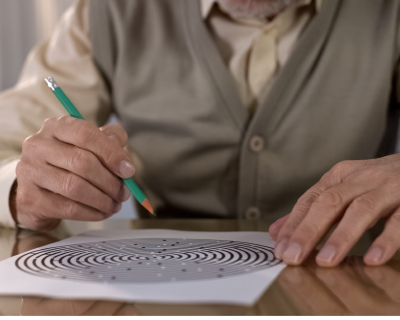 elderly man doing puzzle 