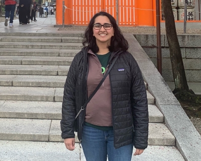 woman stands in front of steps