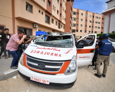 Members of the press take photographs of a damaged ambulance in an Israeli army attack as clashes between Palestinian factions and Israeli forces continue in Khan Yunis, Gaza on October 07, 2023. The paramedics inside the unusable ambulance were seriously injured.