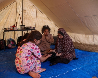 Palestinian children rest in a refugee tent along the Gaza Strip