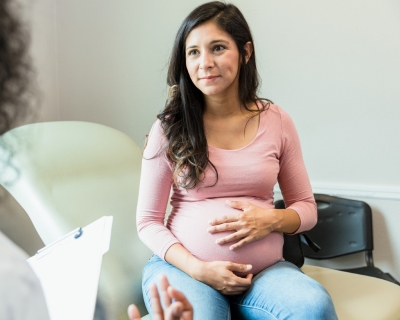 Photo of pregnant woman with doctor.