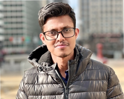 Young man wearing glasses standing in urban setting