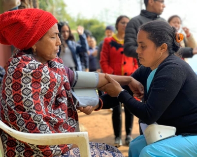 Community health worker in Nepal takes a blood pressure screening