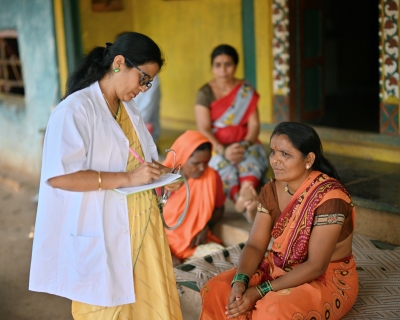 Doctor giving out prescription in rural India.