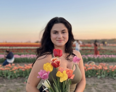 Young woman standing in field of flowers