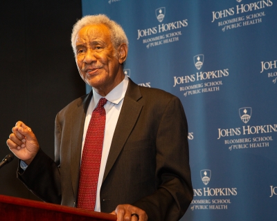 Dr. Taha Taha standing at a podium