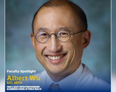 A headshot of a man wearing a white collared shirt.