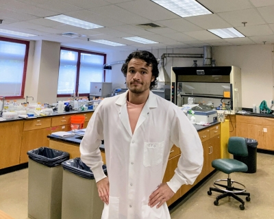 EHE-Ciaran-Cole Male in a white lab coat in a lab