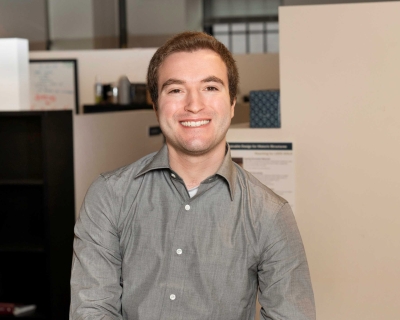 man in button-down shirt standing in an office