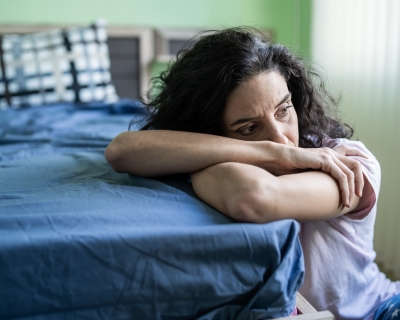 image of white woman leaning against bed