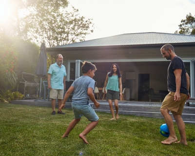 Family playing soccer outdoors