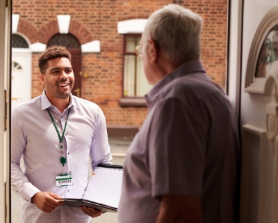 Young man talking to senior citizen