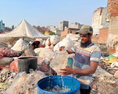 Mohammad Hanif washes recyclable materials pulled from the Bhalswa landfill in Delhi, on October 5, 2022. Image by Cheena Kapoor
