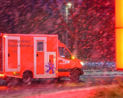 An ambulance drives through Laatzen, Germany in heavy snow during a surge in COVID-19 cases on January 31, 2022.