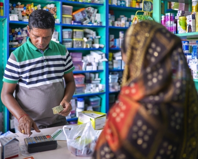 A pharmacist attends to a customer in an Indian pharmacy.