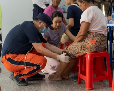 A member of China Search and Rescue Team provides medical consultations for local residents in Mandalay,  Burma (Myanmar),